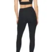 Närmare bild på en modell bakifrån som har Röhnisch Flattering High Waist Tights, Black på sig