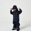 En barnmodell har på sig En klassisk och snygg Kids Wings Raincoat regnjacka (barn)